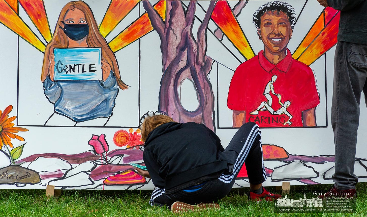 Amateur and more accomplished artists work to create a Kindness Mural at a rally by Neighbor2Neighborhood on the civic green at city hall. My Final Photo for Oct. 4, 2020.