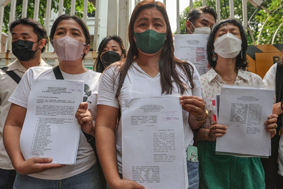 Members of the Tinang 83, a group of farmers and advocates who were allegedly assaulted in Hacienda Tinang in Capas, Tarlac while conducting “bungkalan” or a cultivation activity on June 9, 2022, hold their case documents as they enter the Office of the Ombudsman compound in Quezon City to attend a hearing on June 6, 2023. 