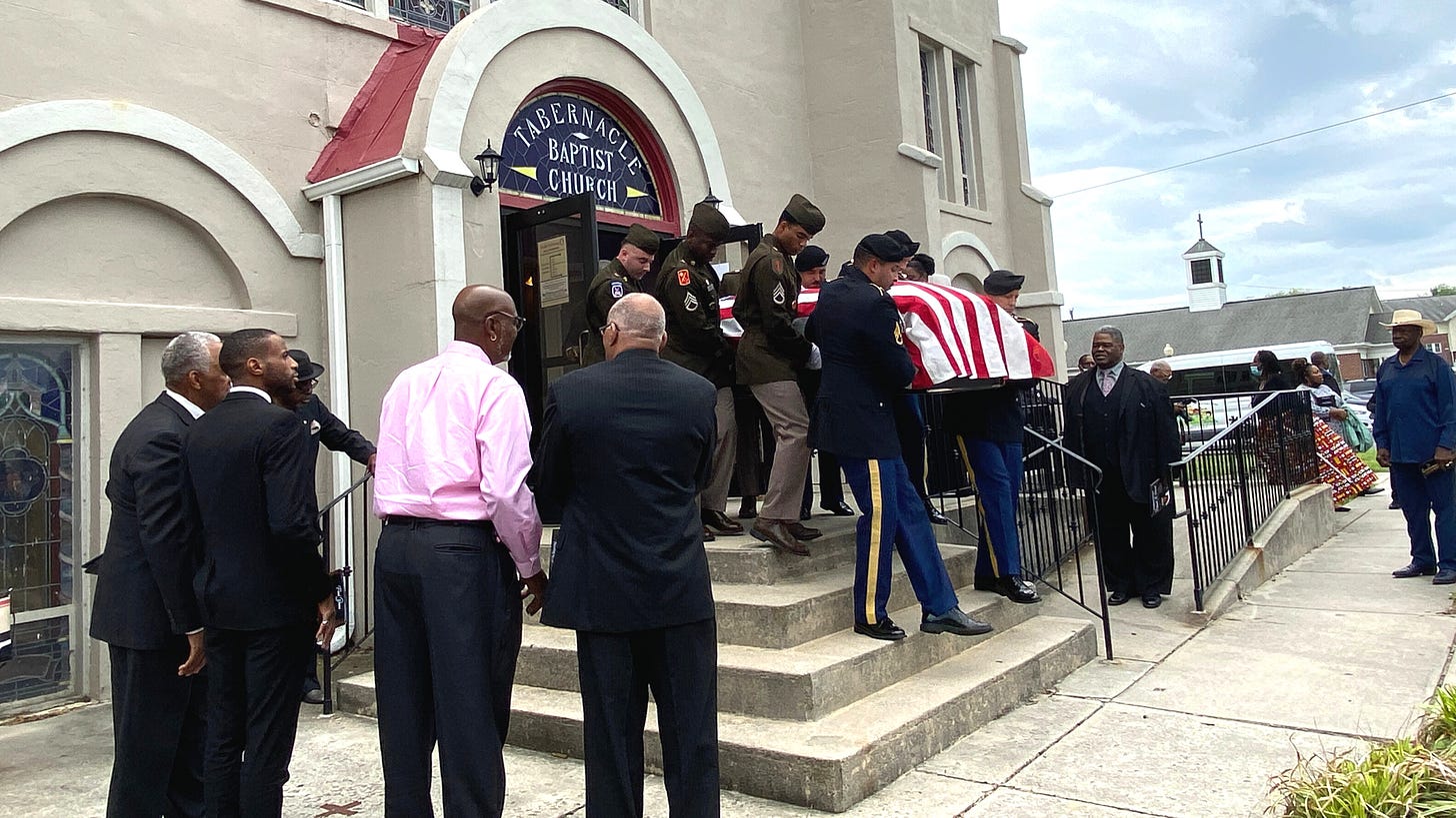 Richard's Stewart's coffin comes down the stairs at Tabernacle Baptist Church