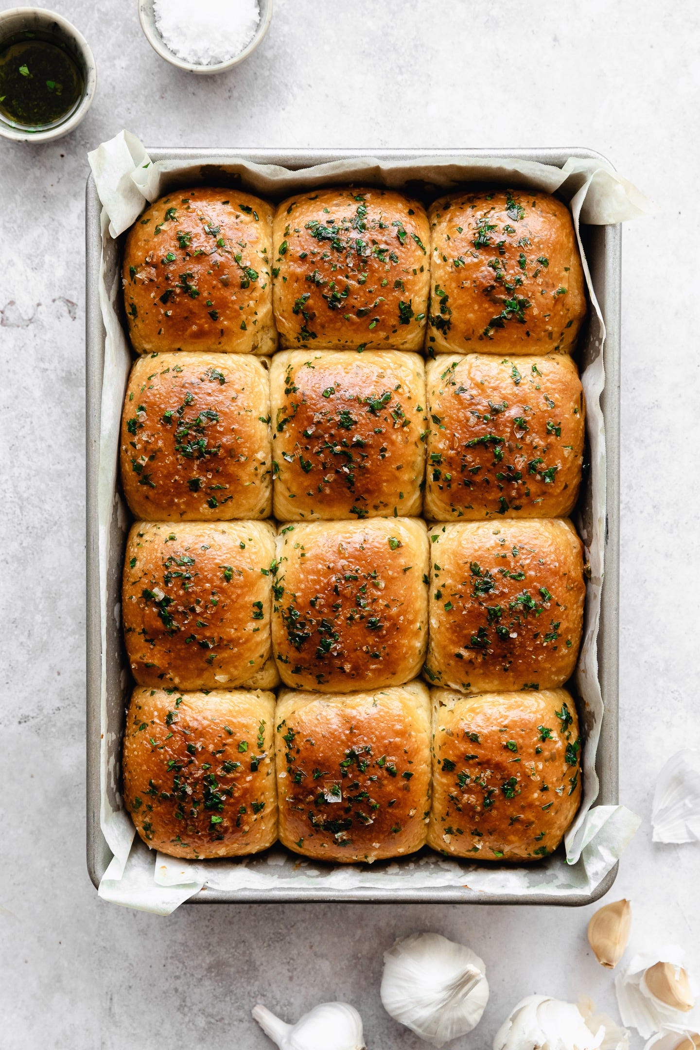 Pan of vegan roasted garlic and herb brioche buns seen from above