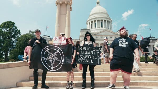 Supporters of the Satanic Temple at a rally for religious liberty in Little Rock, Ark., in 2018 as seen in “Hail Satan?”