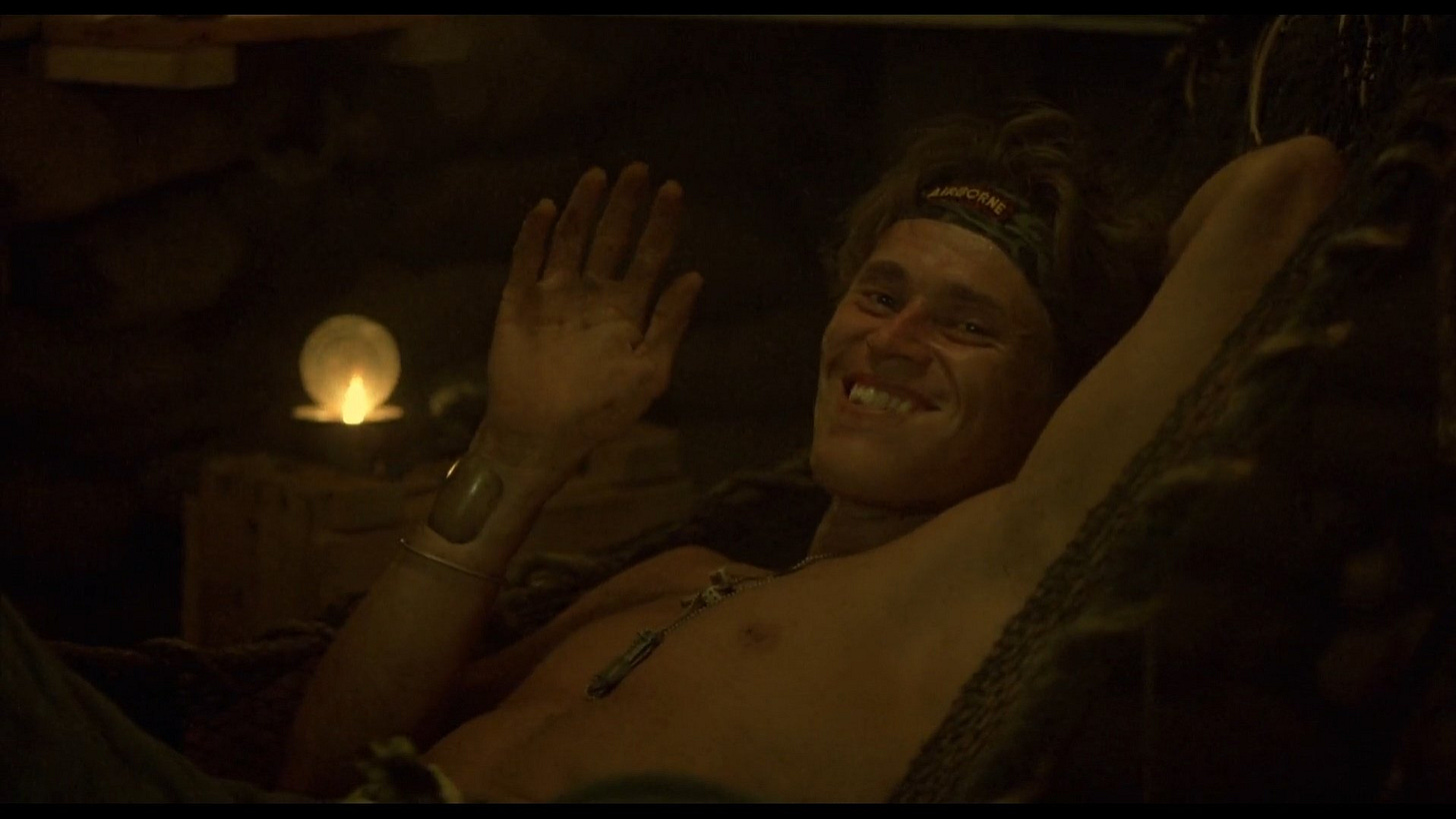 Platoon | Still features a shirtless Willem Dafoe waving and smiling.