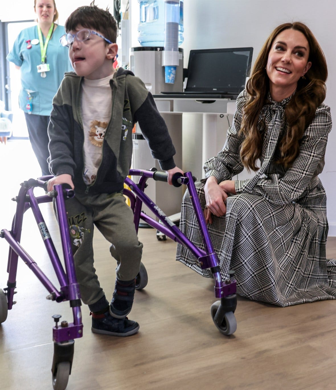 The Princess of Wales speaking with a young boy using a walker at a children's hospice.