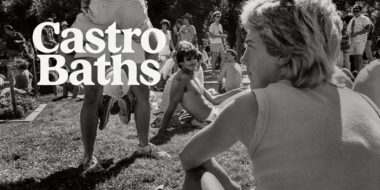 A black-and-white photo of a group of people relaxing in a park, with many sitting or lying on the grass. In the foreground, a person with short, light-colored hair looks towards the group. Prominently, the words “Castro Baths” are superimposed in bold white text.