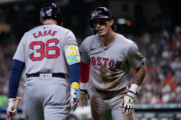 Jarren Duran of the Boston Red Sox, right, celebrates with Triston Casas after scoring in the first inning against the Houston Astros at Minute Maid...