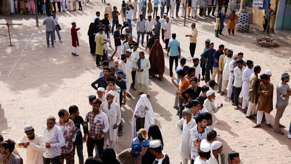Voters line up outside a polling station to vote during the first phase of the general election in Kairana, in the northern Indian state of Uttar Pradesh, India, April 19, 2024.