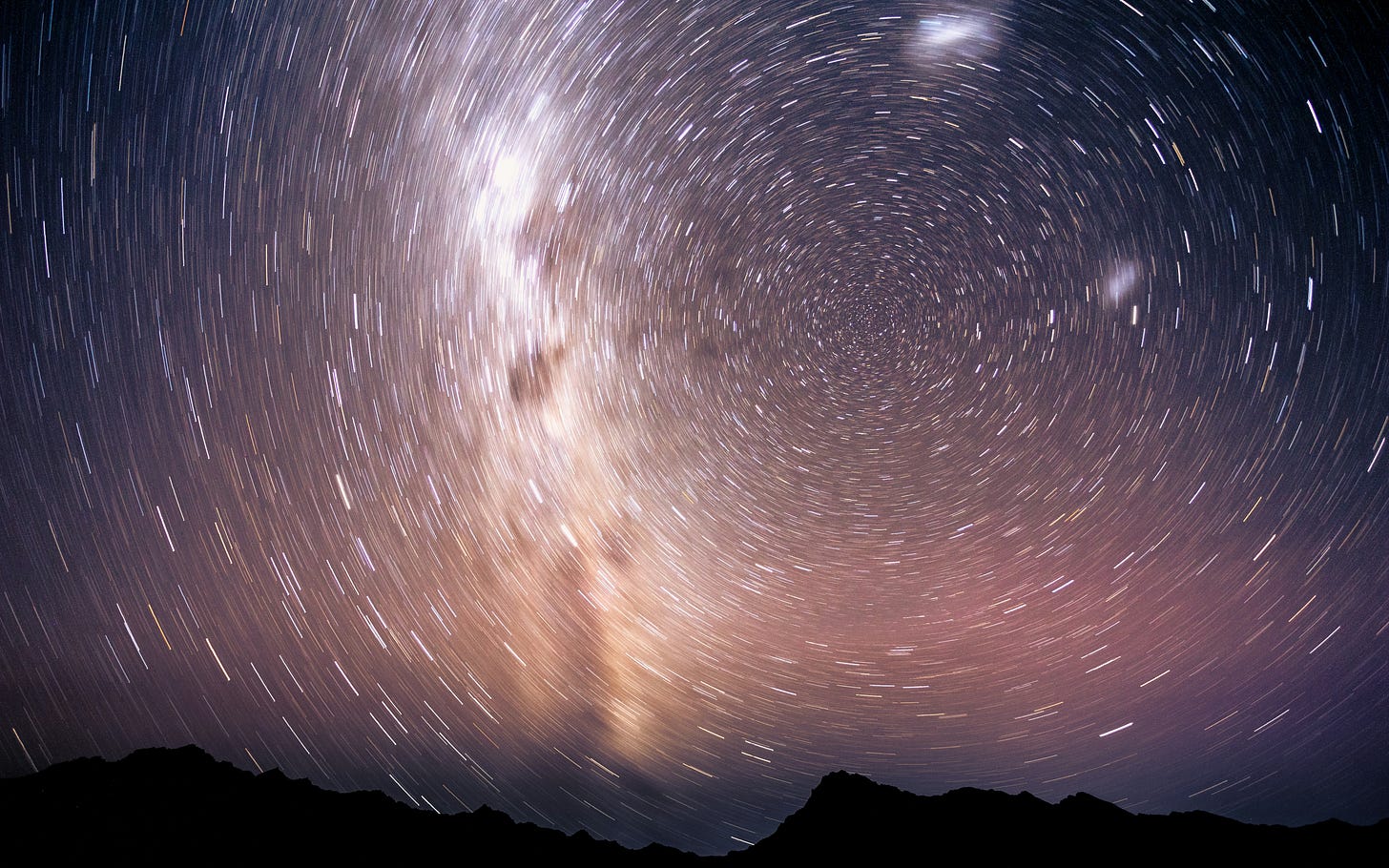 spinning stars above mountain range