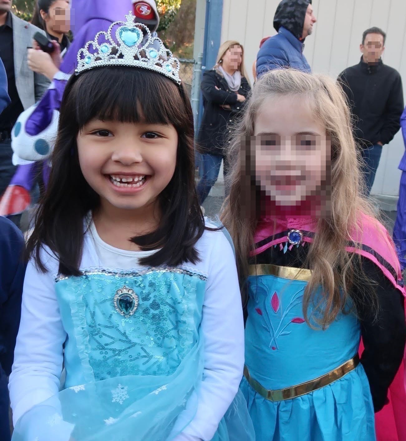 Two girls dressed up as Elsa and Anna from the movie Frozen