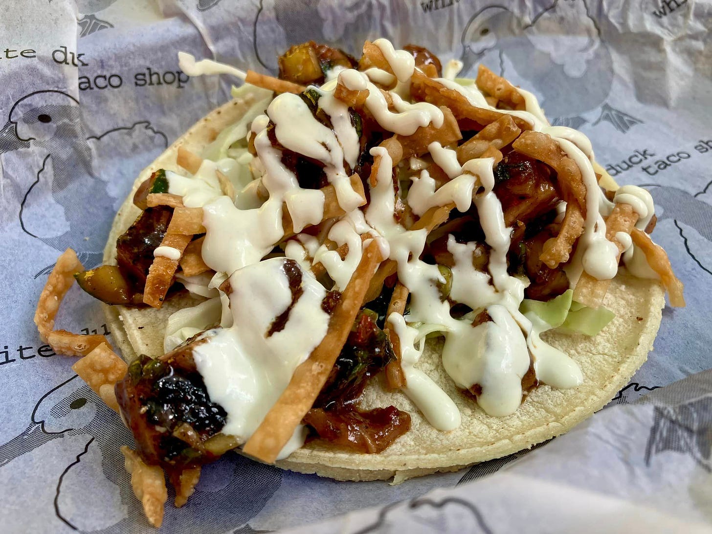 May be an image of taco, gyro and burrito