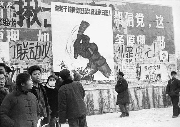 Small group of Chinese youths walk past several dazibao, the revolutionary placards, in February 1967 in downtown Beijing, during the "great...