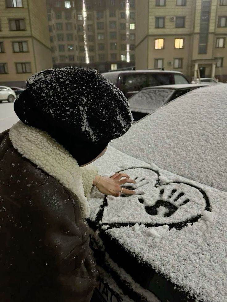 This may contain: a person standing next to a car covered in snow and frost with mickey mouse drawn on it