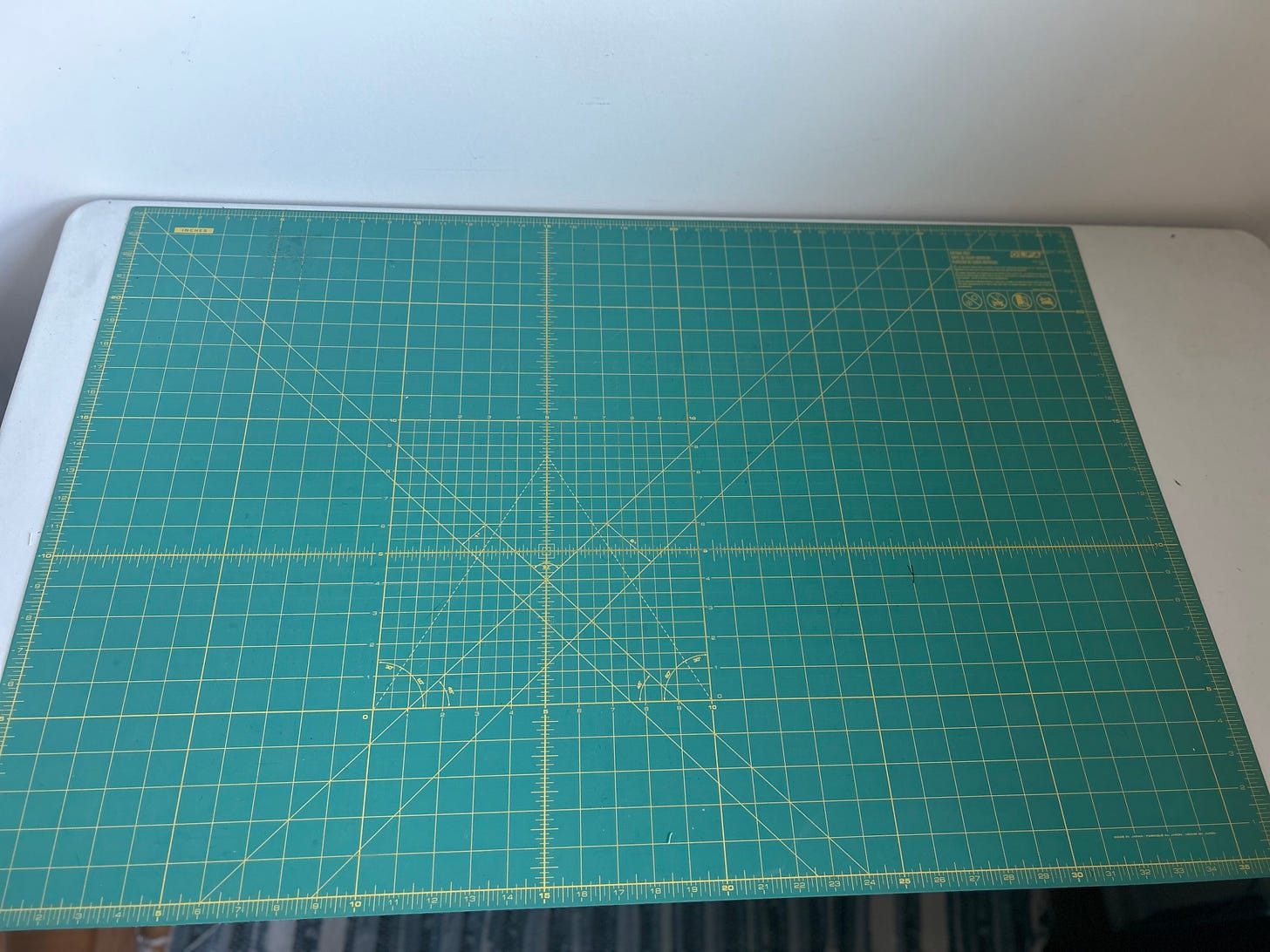 large green cutting mat on a white table
