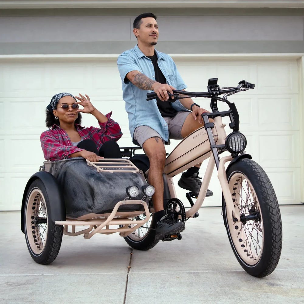 A MOD Easy SideCar 3 electric bike rider with an adult passenger in the sidecar feature. 