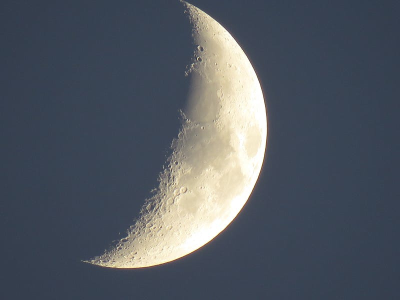 Waning moon against dark sky