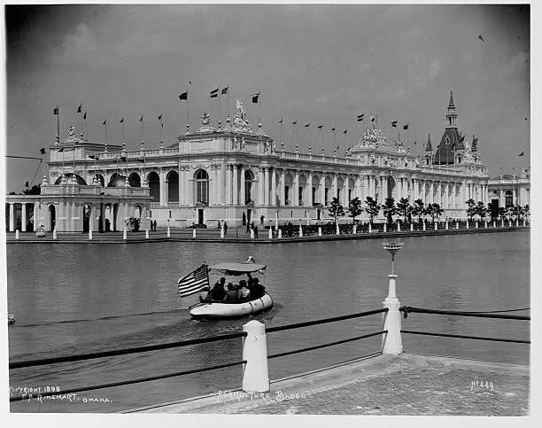 Visitors ride in boats on a man-made lagoon on the grounds of the Trans-Mississippi Exposition in 1898. Omaha, Nebraska, USA.