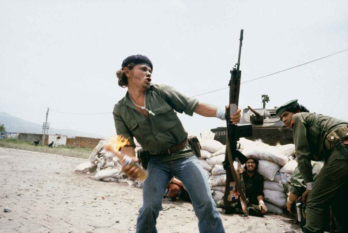 A member of the Sandinastas throws a Molotov cocktail at National Guard headquarters in Esteli, Nicaragua, ...