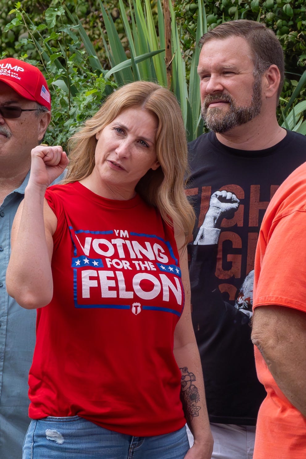 A person in a red shirt with a person in a hat and a red hat

Description automatically generated