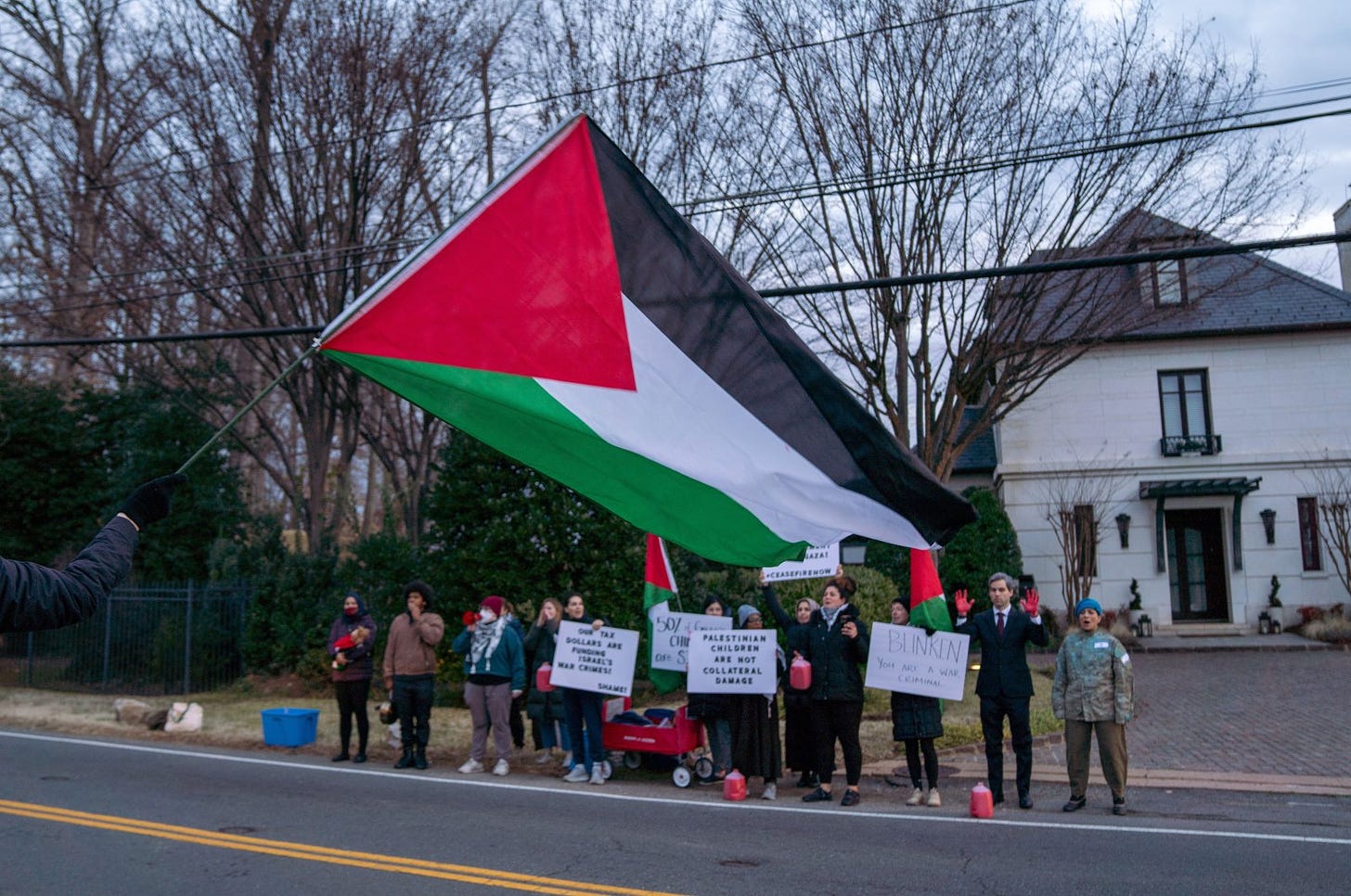 A group of pro-Palestine activists stage a protest, spilling fake blood on the streets and over his car as he left for work in front of U.S. Secretary of State Antony Blinken’s House in McLean, VA, Jan. 4, 2024. (AA Photo)