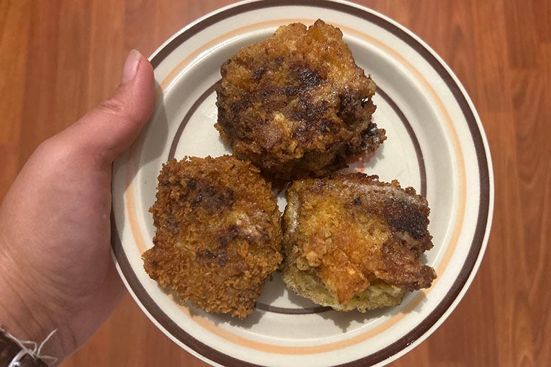 Three 'bitterballen' on a plate.