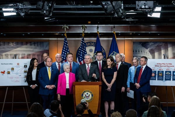 James R. Comer, the chairman of the House Oversight Committee, stands behind a lectern and speaks alongside the Republican members of the committee.