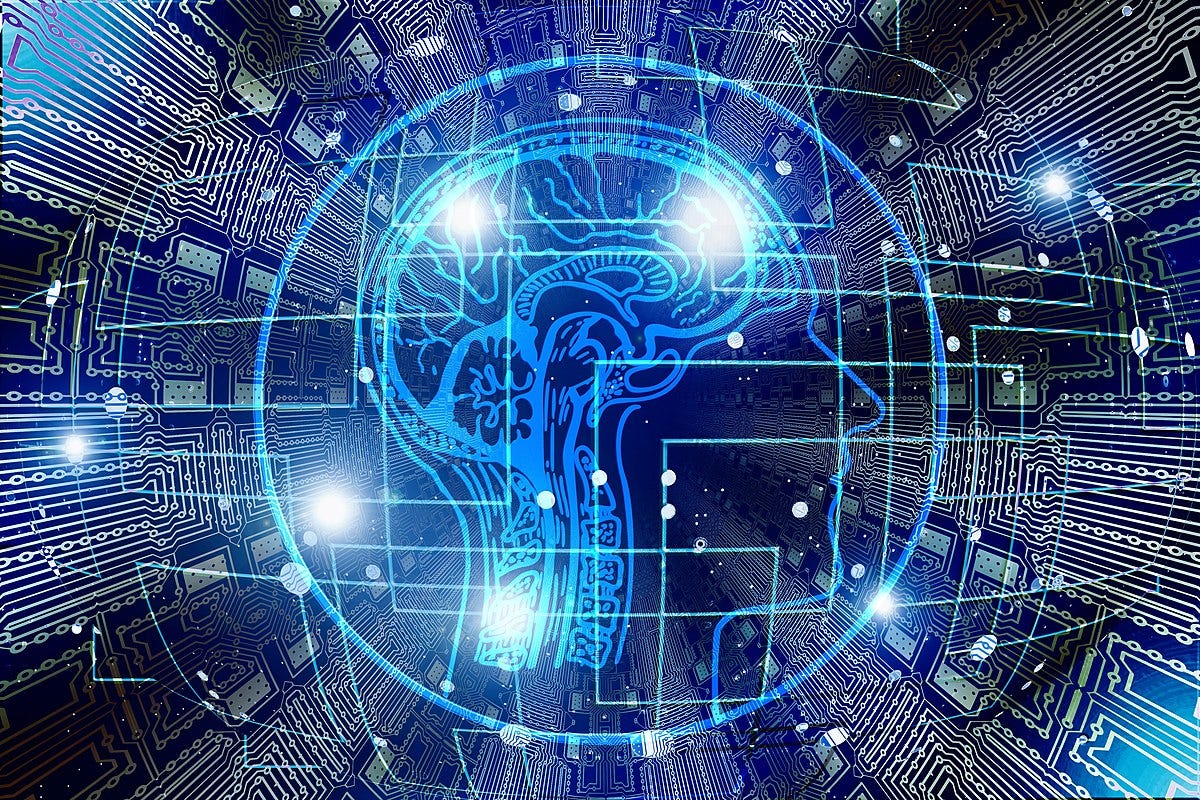 Stock image. Circuitry forms a background to an image of a stylized, vertically bisected human head in profile. It looks vaguely like a coin to me. Mostly in blue, black, and white.