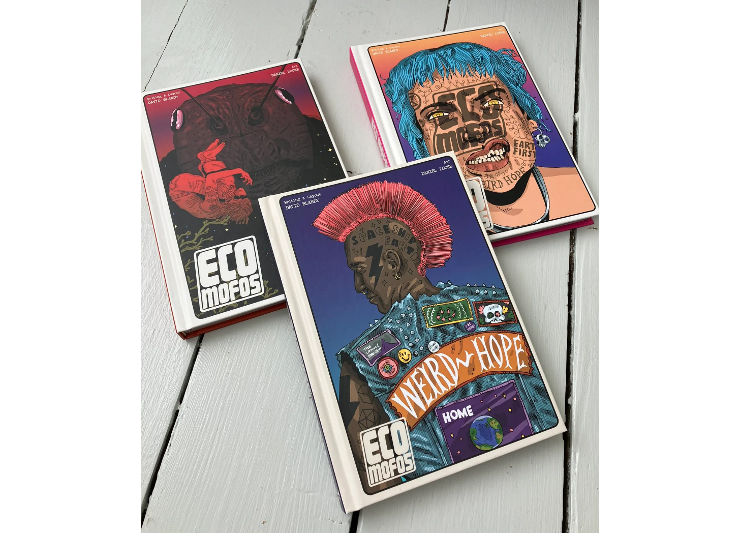 Three covers of hardback book, Eco Mofos. Colorful punk illustrations of a girl punk, mohawk punk and a giant roach.