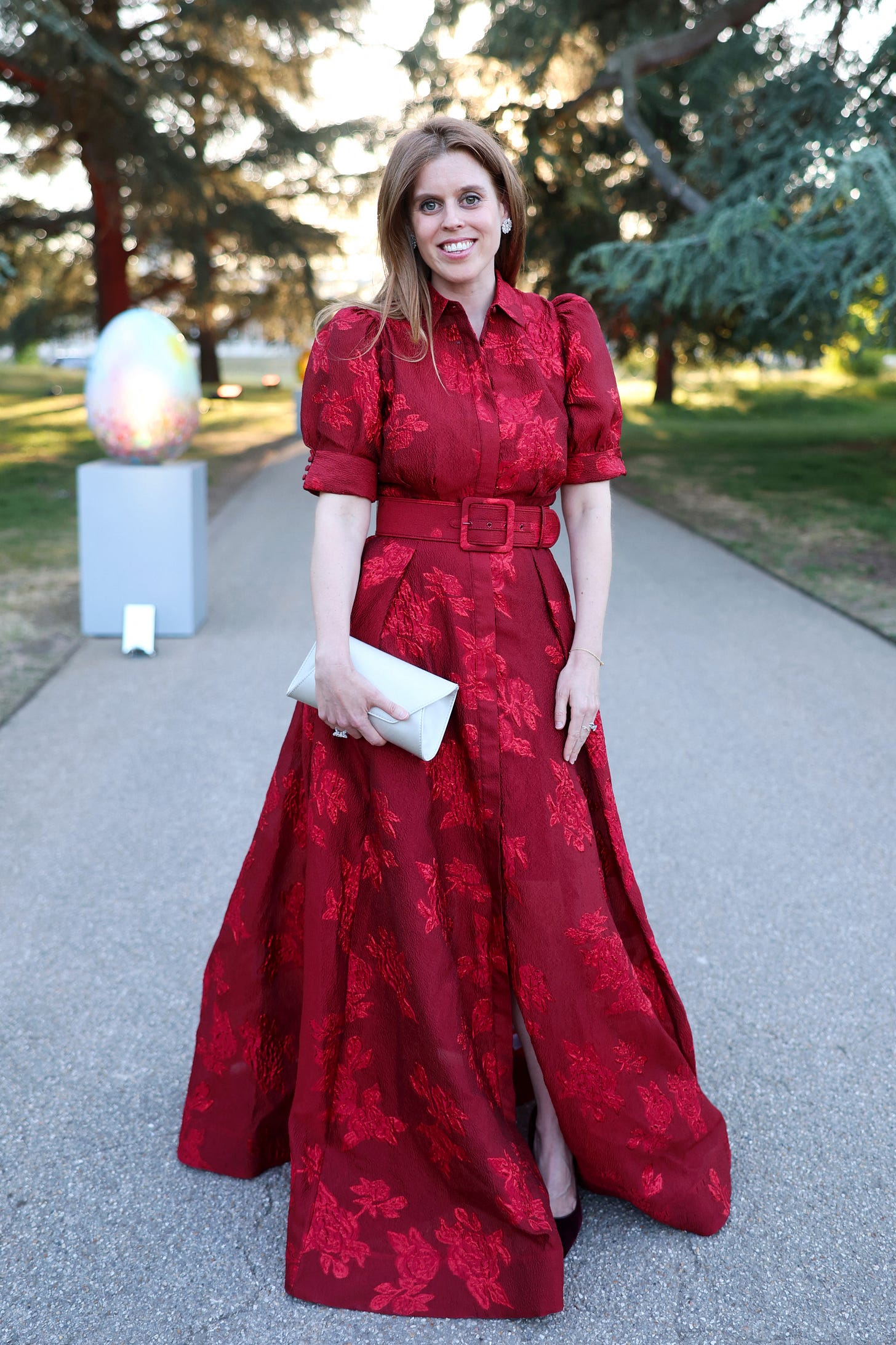 Princess Beatrice wearing a red dress outside