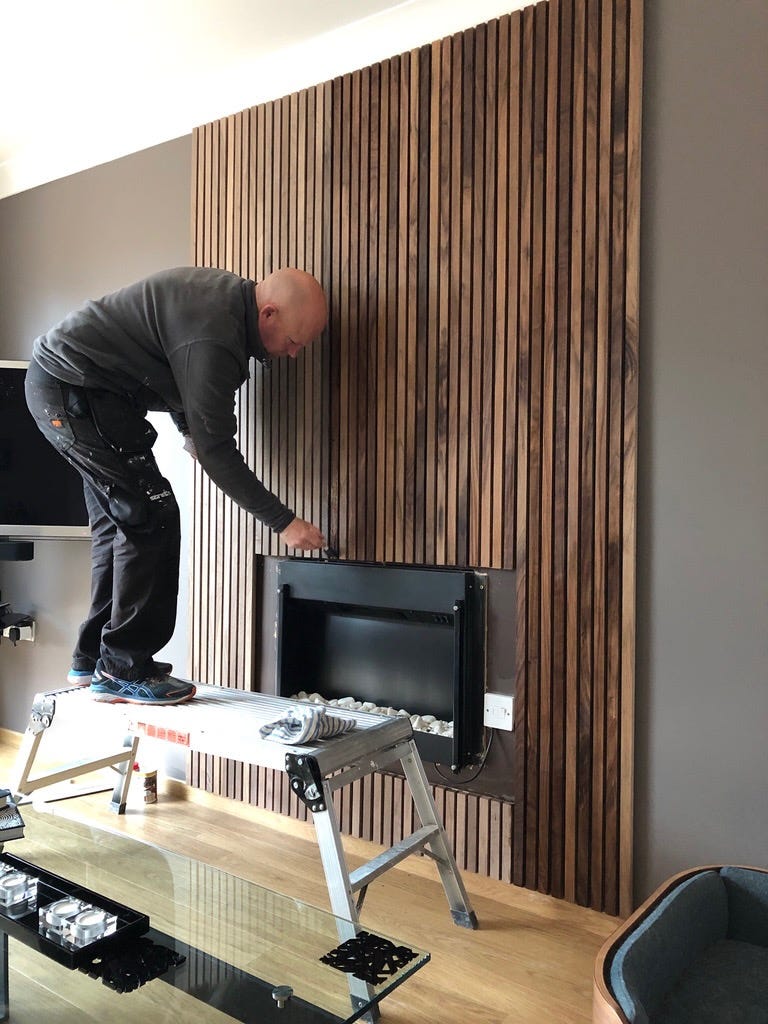 oiling the feature wall to bring out the natural grain and colour of the wood