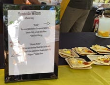 framed menu on a table next to a handful of dishes of food