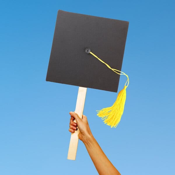 A photo illustration of a graduation cap held aloft on a wooden stick, resembling a protest sign.
