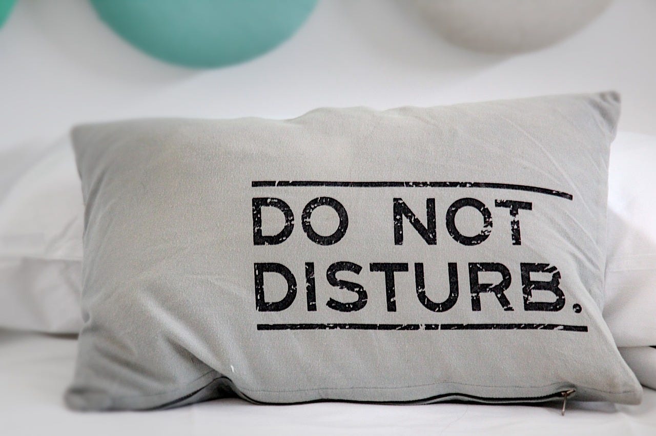 pillow with "Do Not Disturb" message