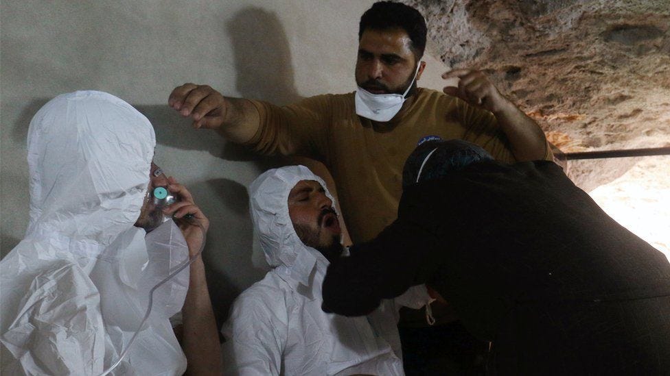 A man breathes through an oxygen mask as another receives treatment after what rescue workers described as a suspected chemical attack in the town of Khan Sheikhoun in rebel-held Idlib, 4 April 2017