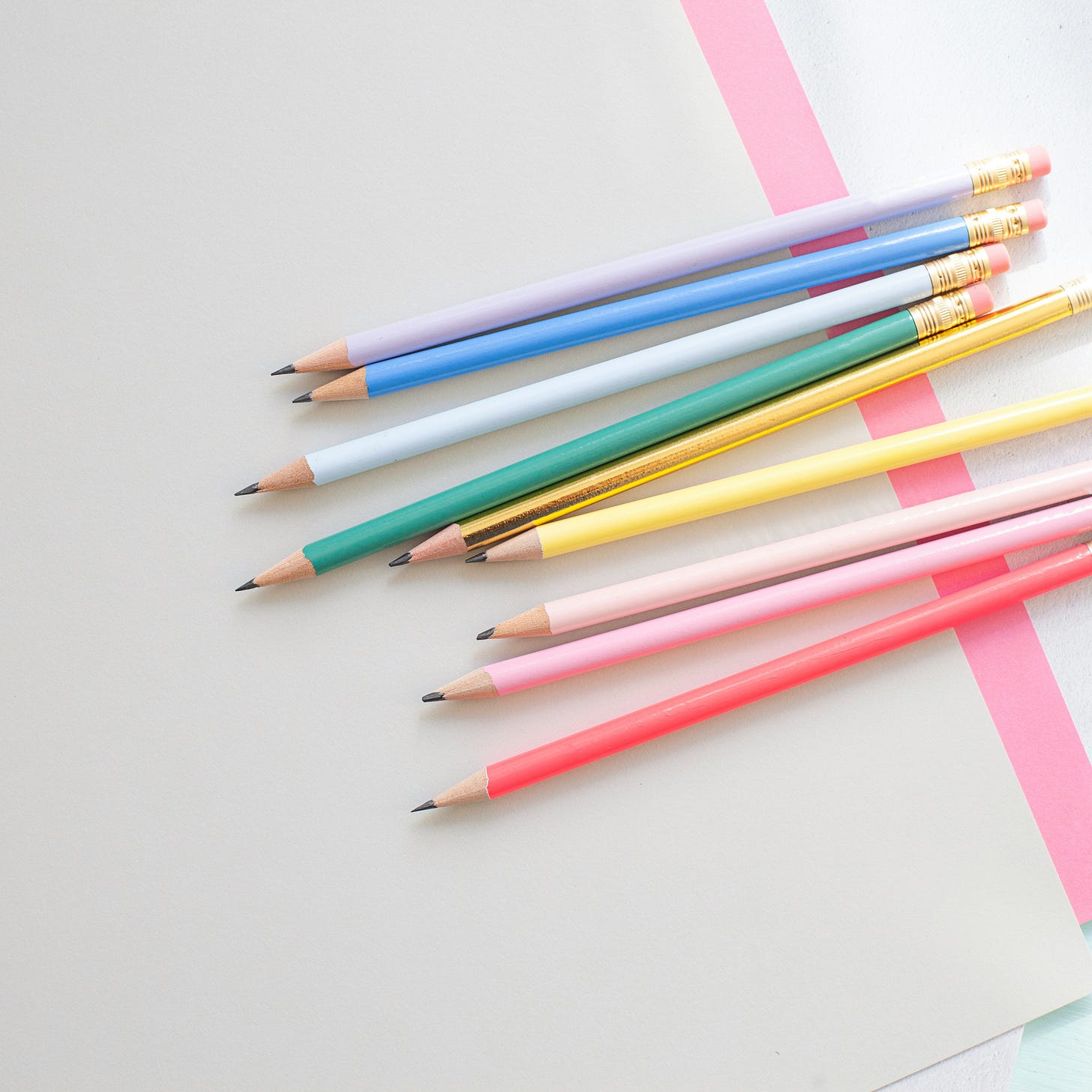 sharpened pencils with different colors on white background