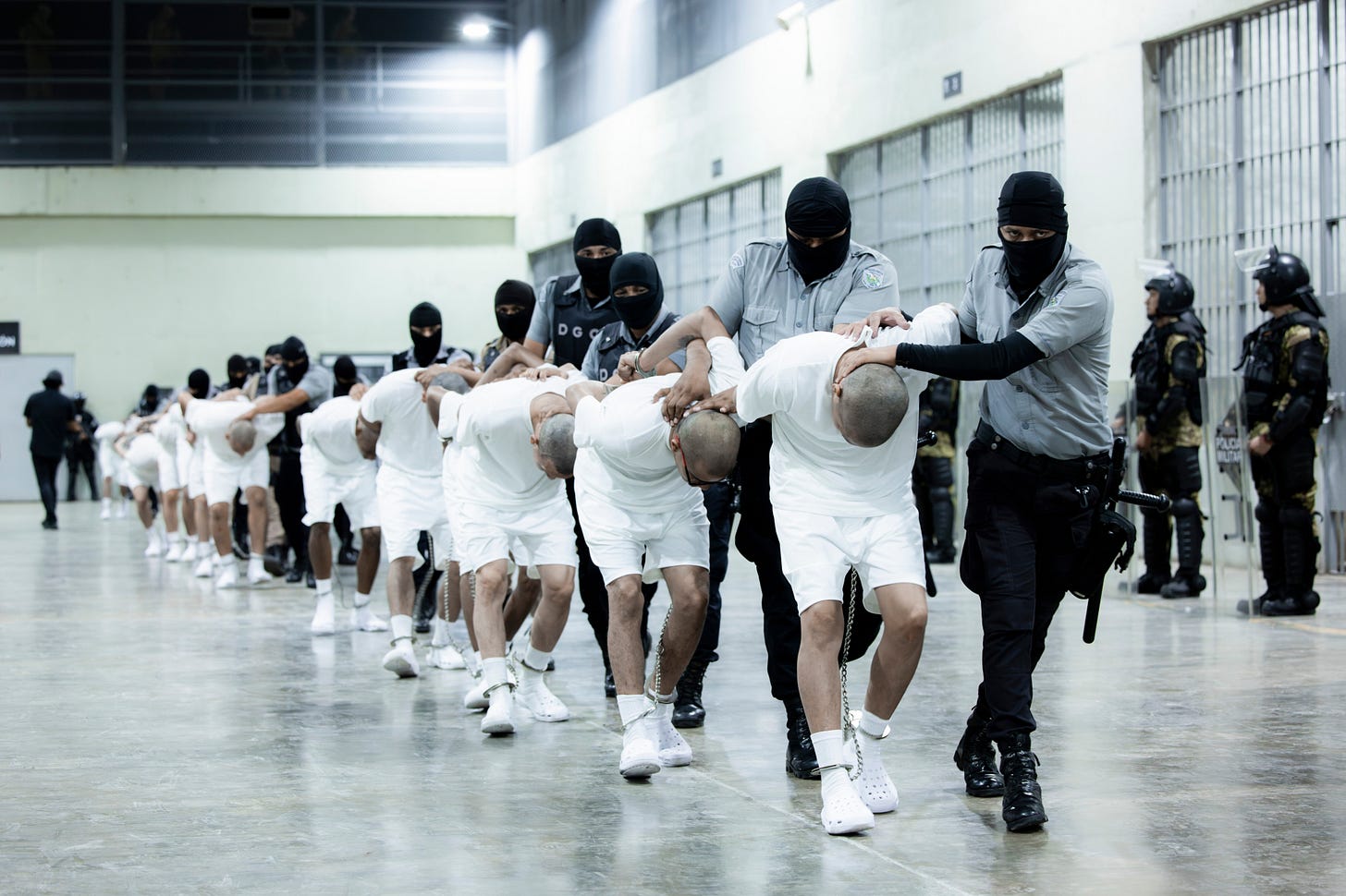 Prison guards transfer deportees from the U.S., alleged to be Venezuelan gang members, to the Terrorism Confinement Center in Tecoluca, El Salvador, on Sunday March 16 2025