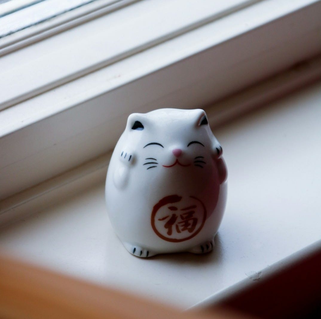white and red ceramic cat figurine white and red ceramic cat figurine