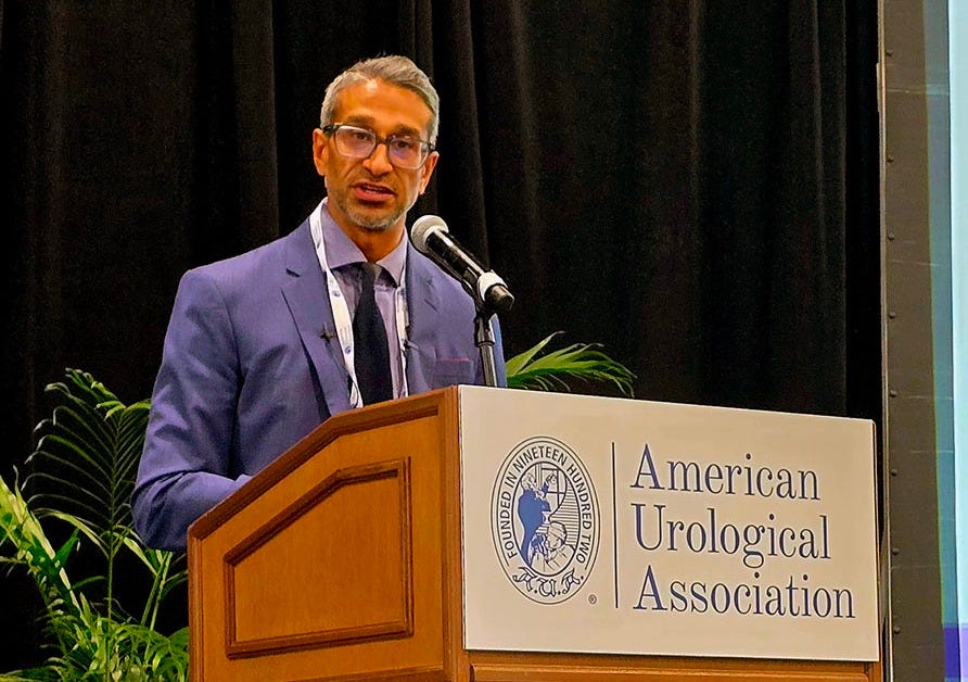 Dr. Sanoj Punnen speaking from a podium at AUA 2025