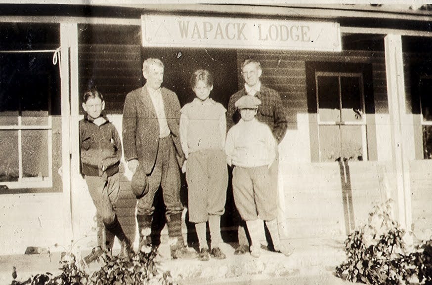 Five people on porch of the Wapack Lodge