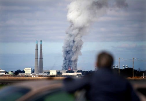 A bystander watches the smoke and flames from Castroville as a fire at the Vistra battery storage plant burns in Moss Landing, Calif., on Friday, Jan. 17, 2025. (Doug Duran/Bay Area News Group)
