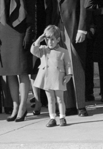 A child saluting with a group of people

Description automatically generated