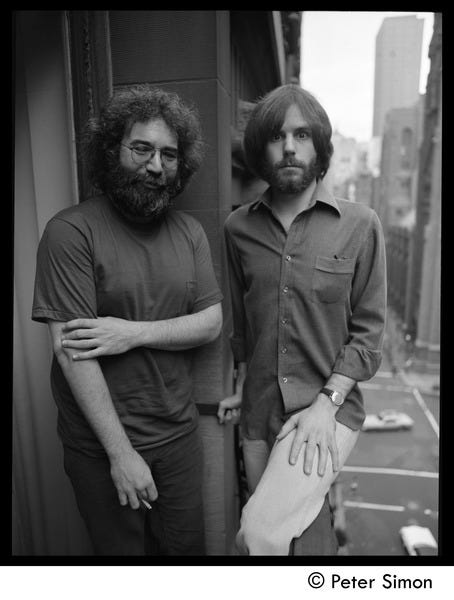 Jerry Garcia (left) and Bob Weir of the Grateful Dead standing on a balcony, ca. 1977