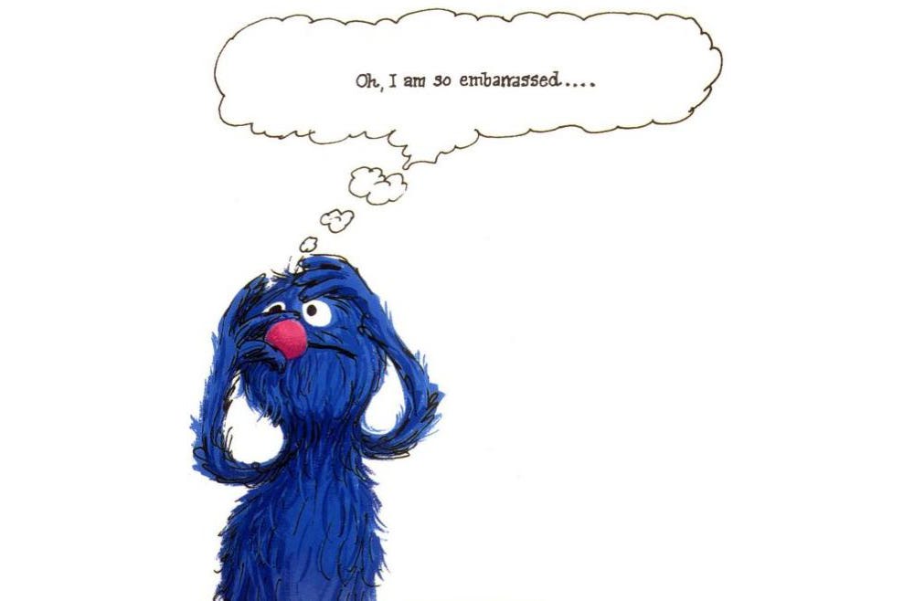 An illustration of Grover, the blue furry Muppet from Sesame Street, with a large red nose, looking upward and touching his cheek in a bashful manner. A thought bubble above his head reads, 'Oh, I am so embarrassed....' His wide eyes and raised eyebrows suggest a comical level of embarrassment.