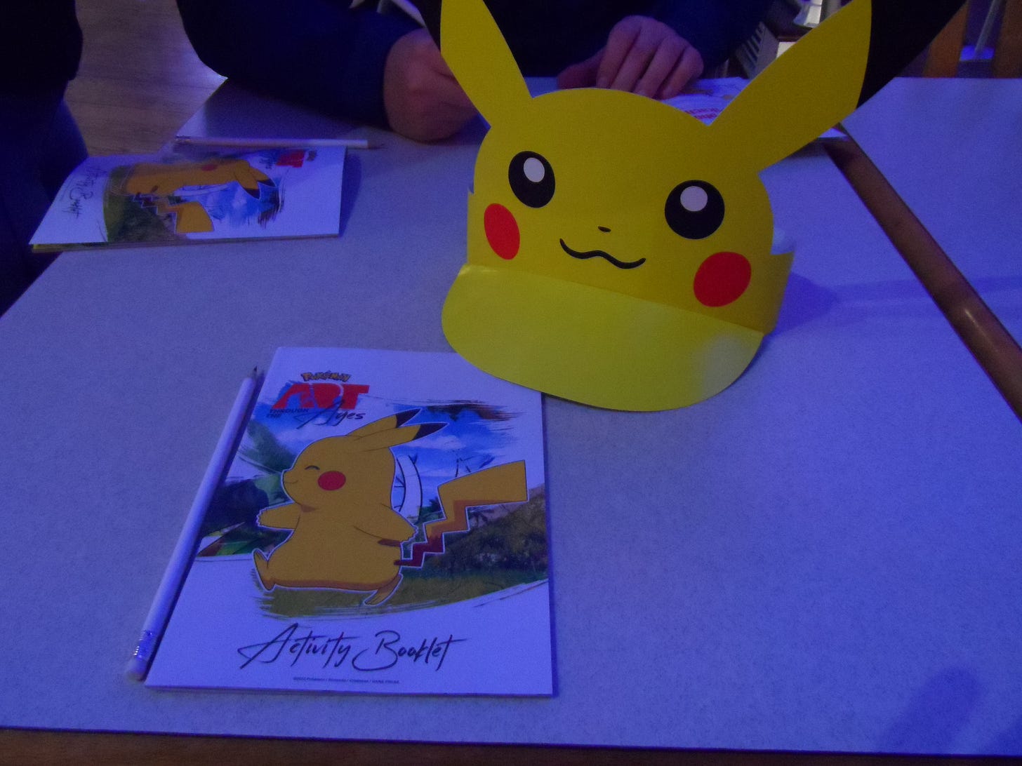 The Pokémon: Art Through the Ages Activity Booklet, and Pikachu hat that I wasn’t quite brave enough to wear…