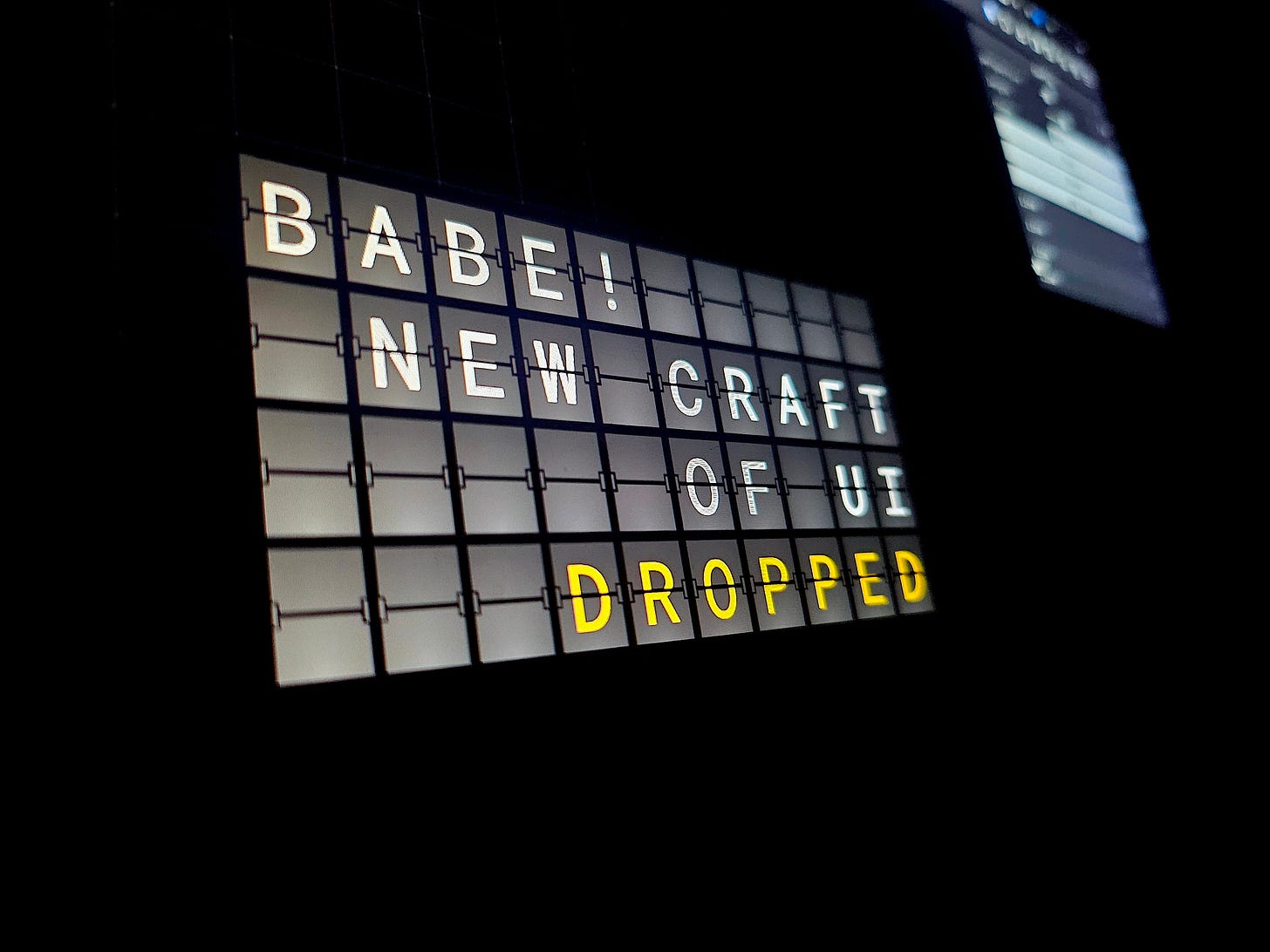 Jhey's laptop showing the digital split flap display