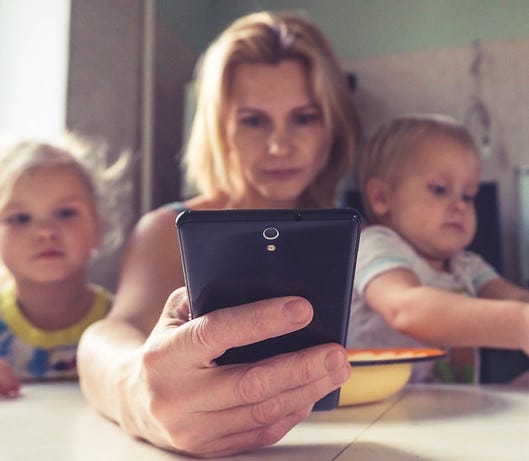 A woman uses smartphone while sitting wi