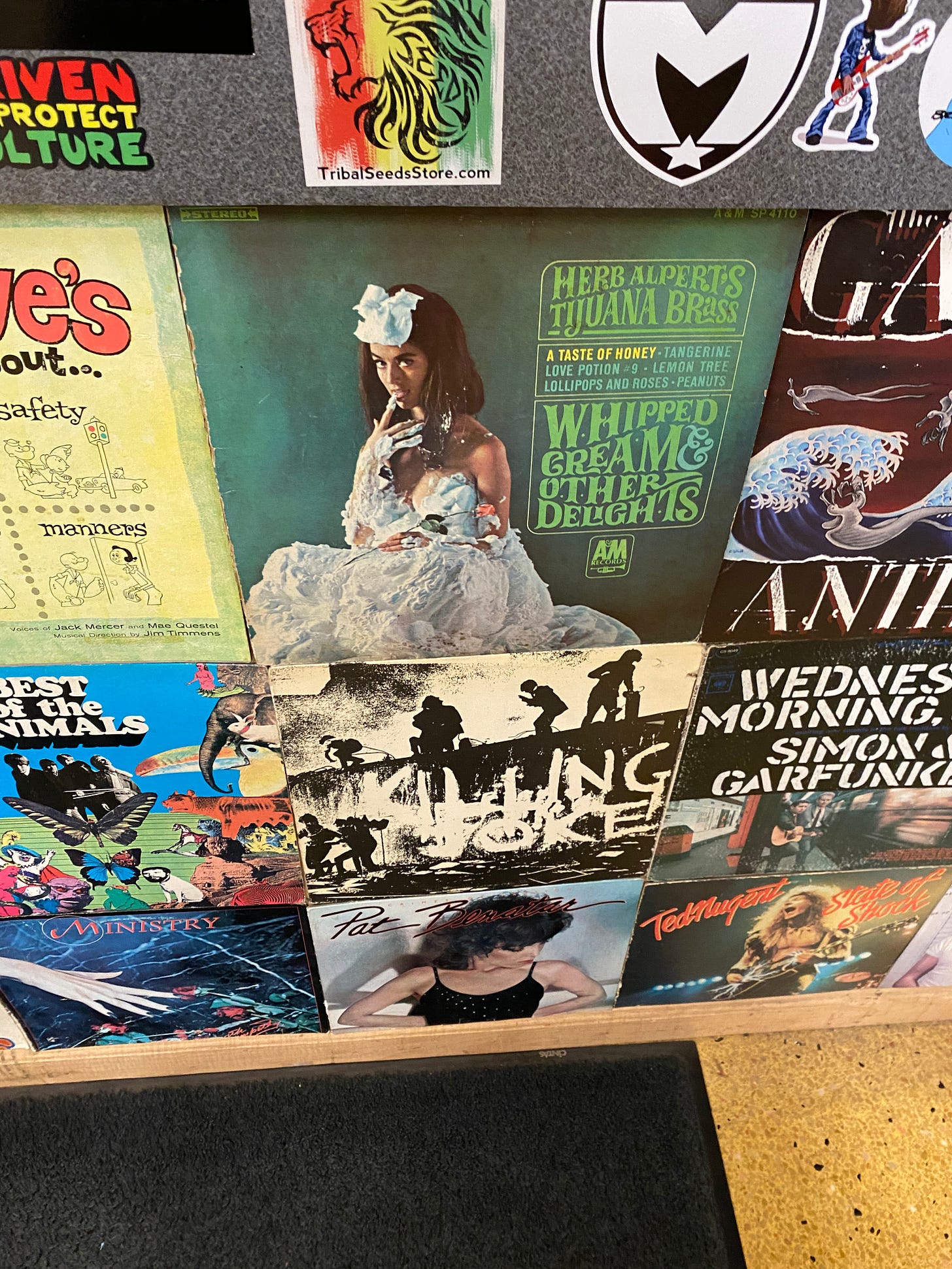 A colorful distplay of music stickers and the covers of old vinyl albums 