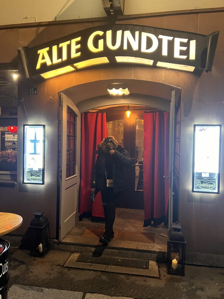 A photograph of me taken at the entrance of Alte Gundtei restaurant, a charming spot tucked away in the Old Town of Heidelberg, Germany.