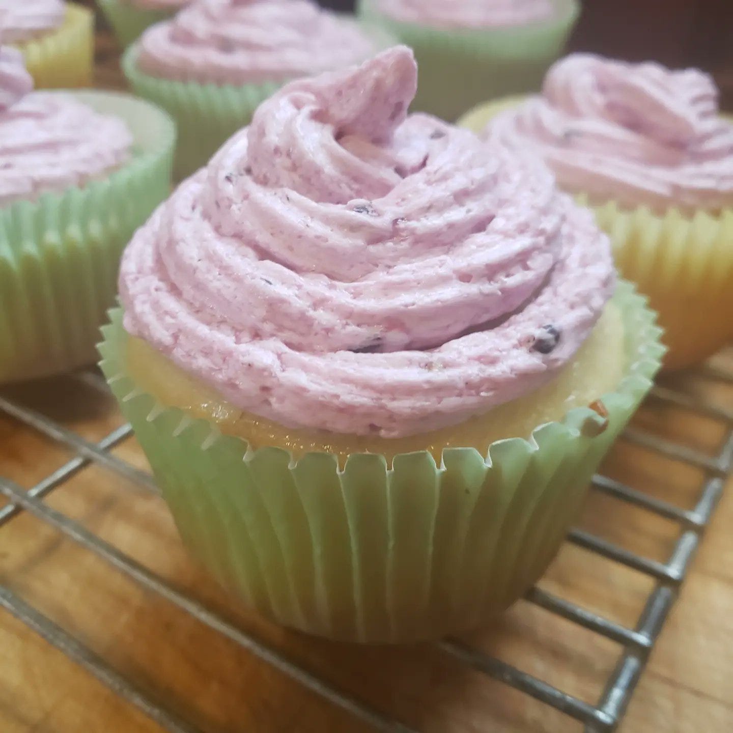 lemon cupcake with a swirl of blackberry buttercream frosting