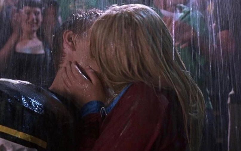 Still from A Cinderella Story showing Austin and Sam kissing in the stands in the rain, him in his football uniform and her in her cute little turquoise and maroon number