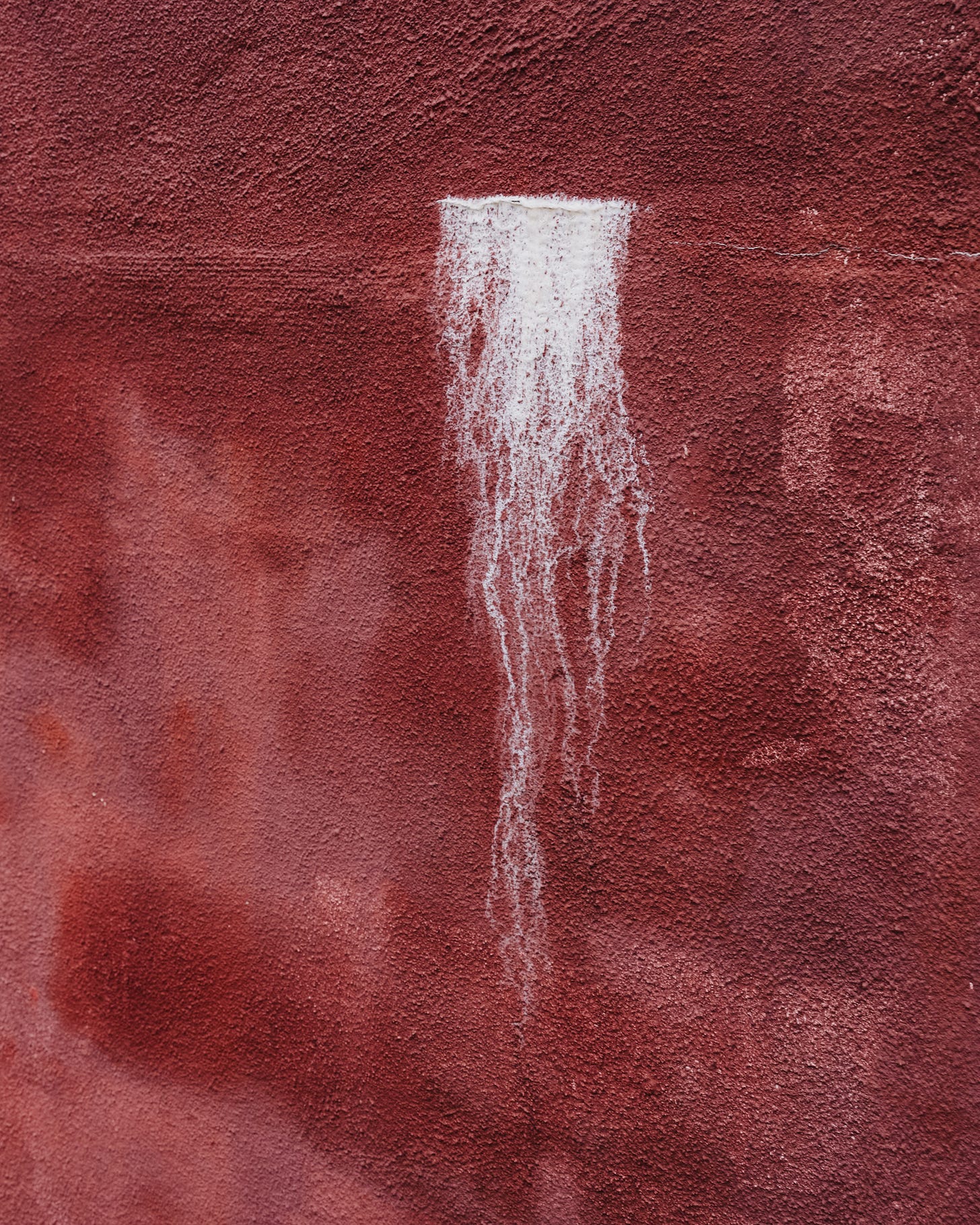 red wall with white splotch