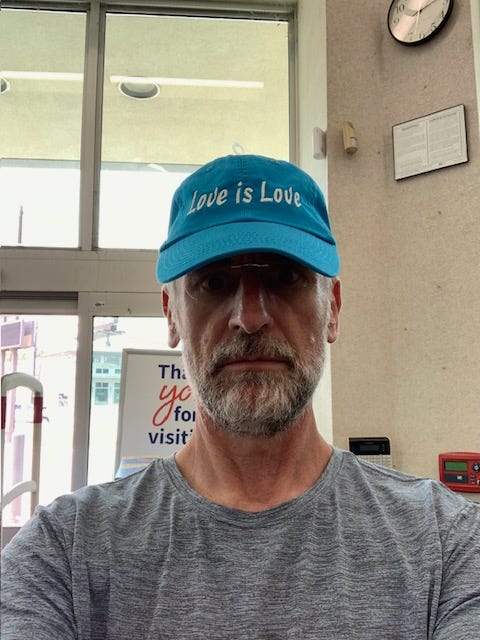 man wearing Love is Love hat